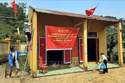 Des habitants de l’ethnie Bru-Vân Kiều du village de Nuoc Dang, commune de Truong Son (province de Quang Tri), décorent le bureau de vote afin de se préparer au scrutin anticipé prévu le 8 mars. Photo : VNA